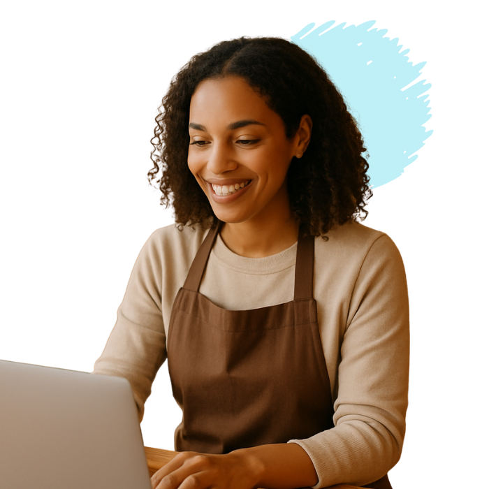 Woman working on laptop, focused expression.