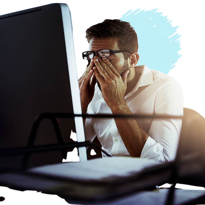 Stressed individual working at computer.